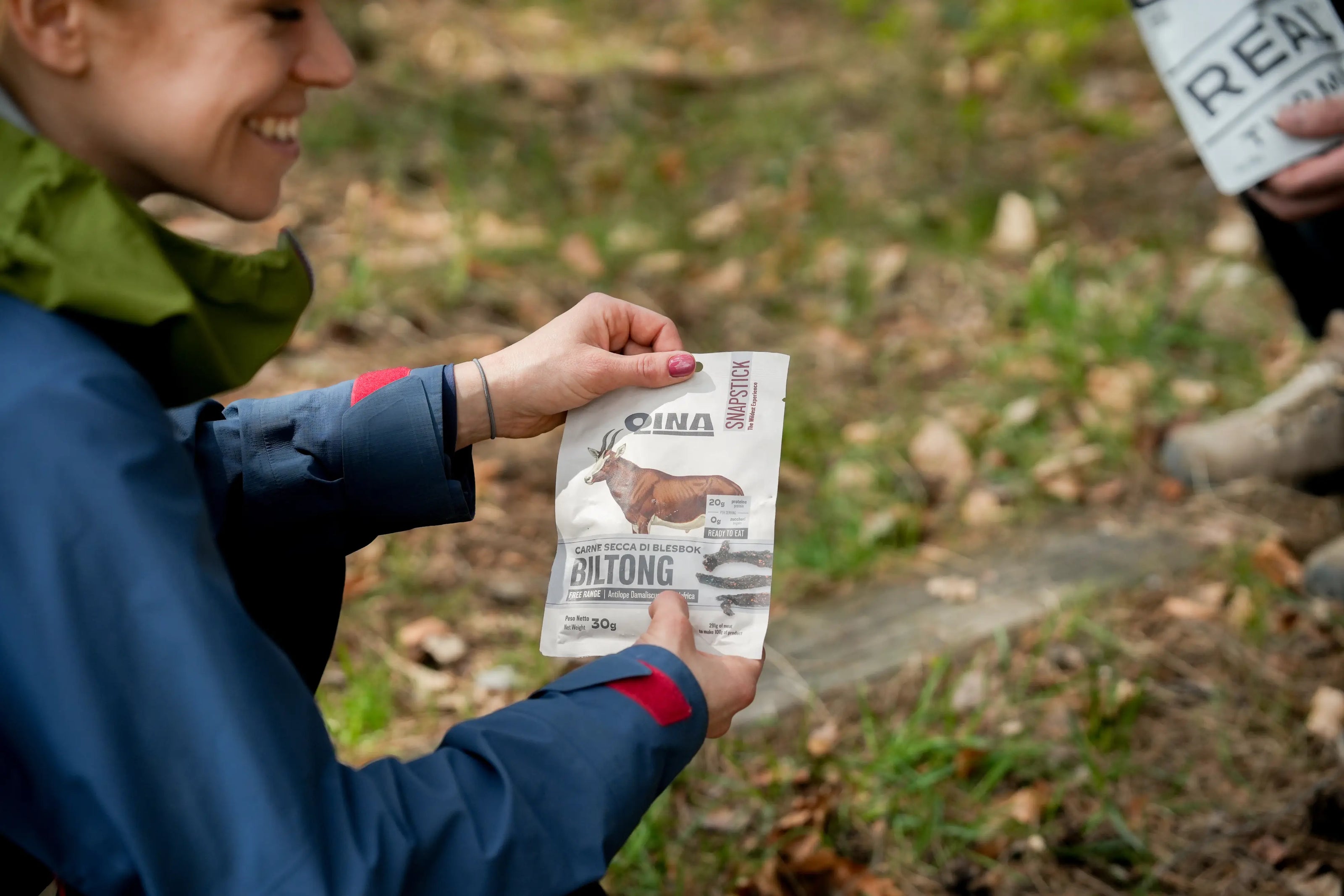 Person holding a product QINA Blesbok package